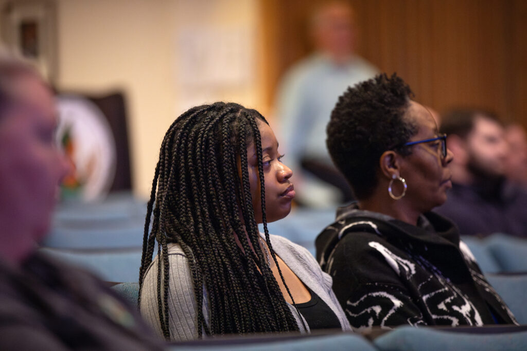 close up of employees listening to speakers at Town Hall Meeting